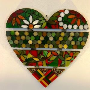 Heart shape wood like base with mosaic artwork on top.